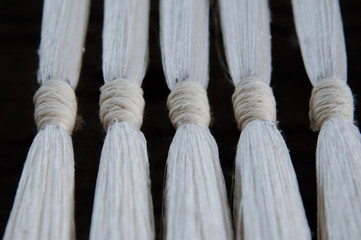 subtle silk weaving thread and yarn closeup. white cotton fiber