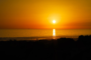 Silhouettes at sunset on the beach of La Barrosa, Sancti Petri, Cadiz, Spain