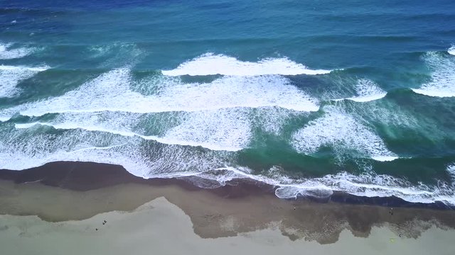 Beautiful aerial view footage of Parangtritis beach with sand and frothy wave in Yogyakarta, Indonesia. Shot in 4k resolution