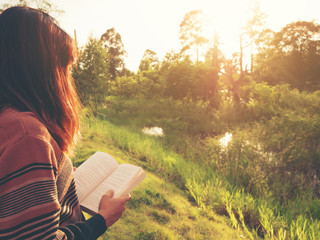 the woman reading the book at nature.