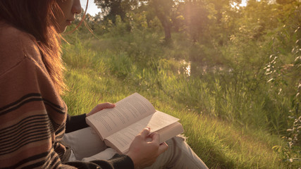 the woman reading the book at nature.