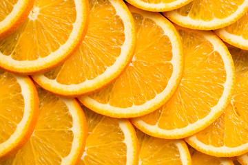 Bright orange background from slices of juicy Orange. Healthy food, background.