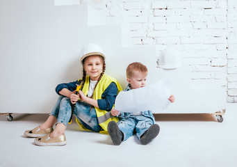 Little girl and boy on the white background. Construction