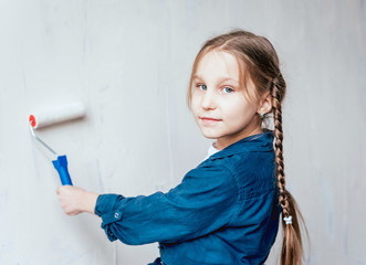 Little girl in a room with a wooden wall. Construction