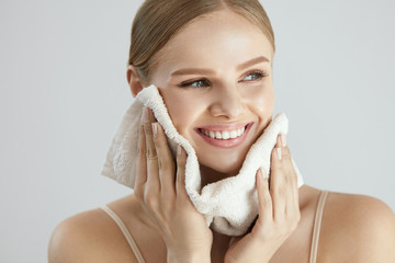 Face Washing. Happy Woman Drying Skin With Towel