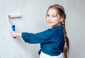 Little girl in a room with a wooden wall. Construction