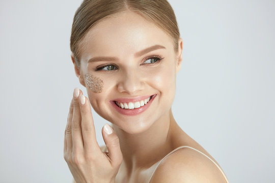 Face Skin Scrub. Smiling Female Applying Scrub On Face Skin