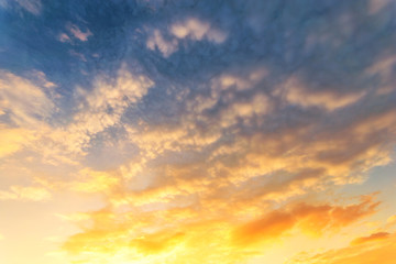 Sky background at sunset,Sky blue and orange light of the sun through the clouds in the sky