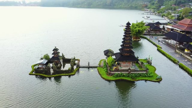 Beautiful aerial view footage of Ulun Danu Bratan Temple from a drone flying around the temple in Tabanan, Bali, Indonesia. Shot in 4k resolution
