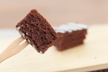 close up of of brownie cake on wooden plate