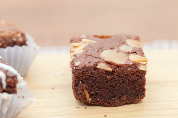 close up of of brownie cake on wooden plate