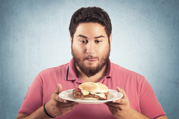 Fat man looking delicious hamburger