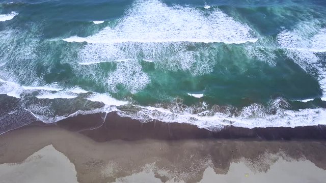Beautiful aerial view footage of frothy wave on Parangtritis beach in Yogyakarta, Indonesia. Shot in 4k resolution