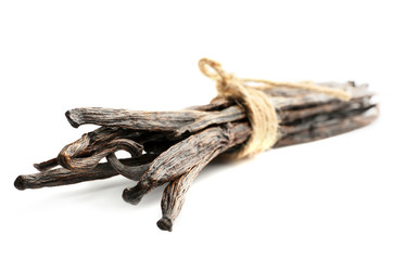 Tied vanilla pods on white background