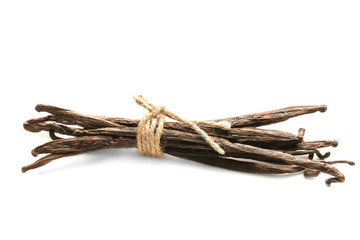 Tied vanilla pods on white background