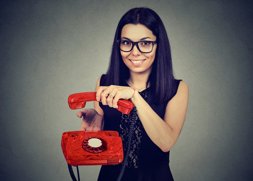 Smiling Woman Hanging Up An Old Phone