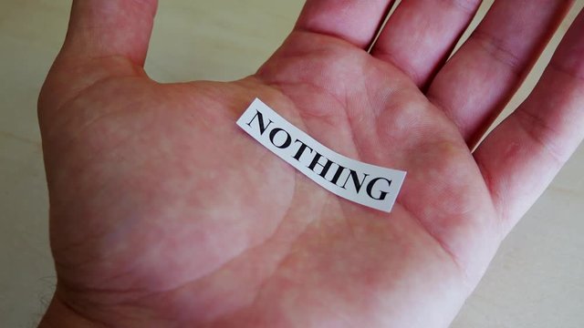 Printed On Paper Letters Word Nothing In Hand. Paper Scraps Word Nothing. Motivation Concept For Business, For Self Belief, Positive Attitude, Motivation