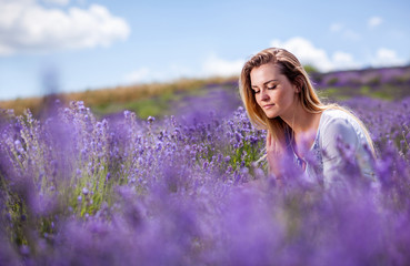 Lovely cute woman in lavender field at sunny day freedom concept