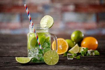 summer refreshing lemonade with ice lime and mint in jar.