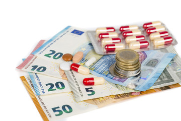 white and red tablets with Euro banknotes and coins.