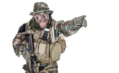 United States Commando half length studio shot. Mouth opened, soldier yelling, emitting intiminate formidable frightening scream pointing finger target and giving attack direction to subordinates