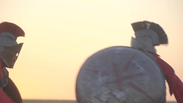 The Greses warrior beats off the attack of another warrior by a round shield and counter attacks by gladus