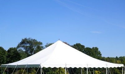 white events tent top against a tree background and a blue sky - 167588047