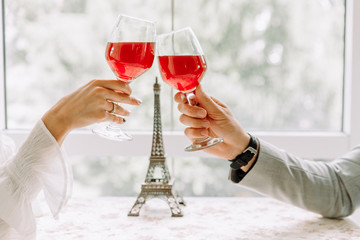 Two people toasting with wine glasses. young couple drinking red wine at restaurant