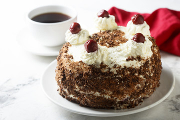 Chocolate and whipped cream cake with cherries