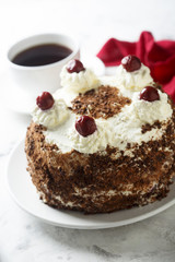 Chocolate and whipped cream cake with cherries