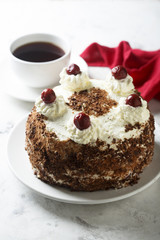 Chocolate and whipped cream cake with cherries