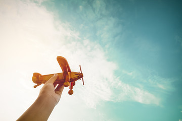 Childhood inspiration - Hands of children holding a toy plane and have dreams wants to be a pilot -...