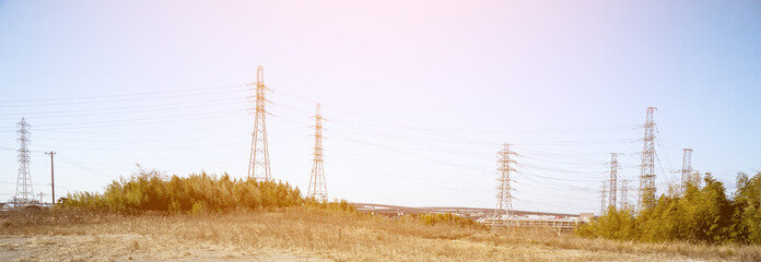 Power line in nature with sun light, wide screen, Technology and nature concept