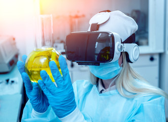 Science technician in virtual reality glasses examines the drug in laboratory.