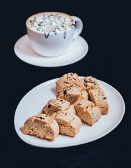 French cookies with jam on the white plate.