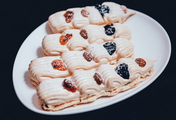 French meringue cookies on the white plate.