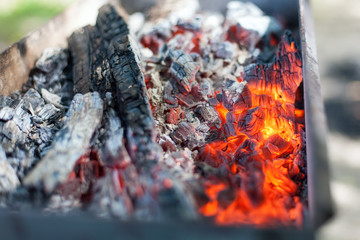 The hot charcoal in the grill