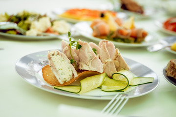 Restaurant table with plates salad, meat and vegetables