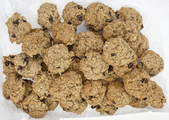 Homemade oatmeal raisin cookies cooling on paper towel.