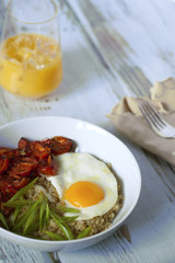 Savory quinoa with broiled tomatoes, green onions and sunny side up egg