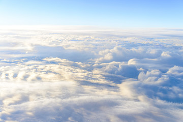 Naklejka na ściany i meble clouds sky skyscape. view from the window of an airplane flying in the clouds, top view clouds like the sea of clouds sky background
