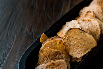 Tarhana cipsi / chips or crackers in a wooden bowl.