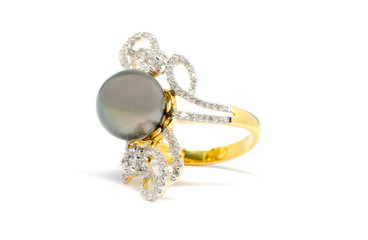 Closed up dark pearl with diamond and gold ring isolated