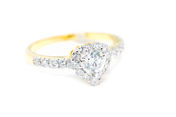 Gold ring with diamond on heart shape isolated