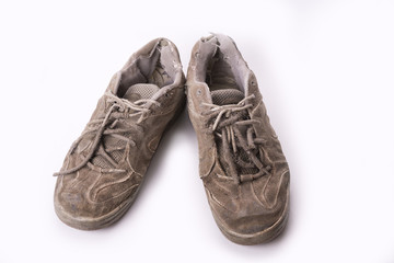 Old wear out tennis shoes isolated on white background