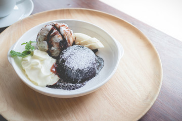 hot chocolate lava cake with vanilla ice cream ball, banana and whipped cream(vintage effect)