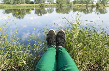 resting in front of the river and green grass