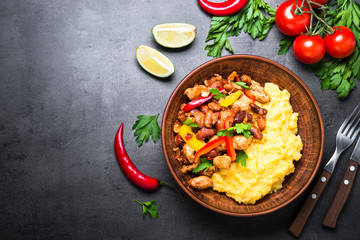 Corn porridge and meat with vegetables and beans in tomato.
