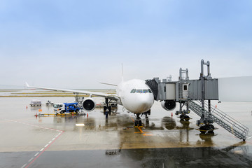 Pre-flight and refueling and Loading cargo service of airplane, Airplane's prepare for take-off in gate,  terminal  international airport. view through window