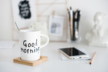 Stylish white desktop, home office interior details with coffee 